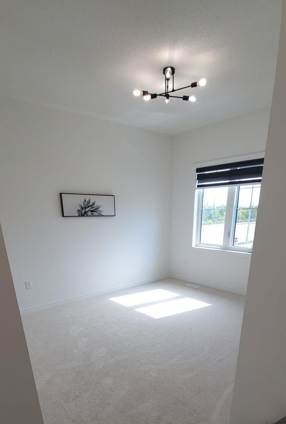 Bedroom with wall art and window